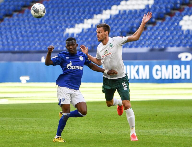 Werder Bremen's Sebastian Langkamp heads the ball ujnder pressure from Rabbi Matondo of Schalke. Reuters