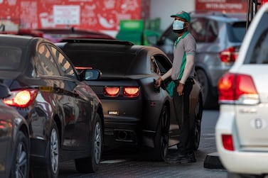 An attendant wears a protective face mask while refuelling a car at a petrol station in Dubai. The UAE has 85 coronavirus cases. Bloomberg