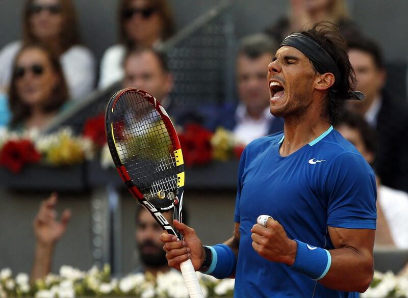 Rafael Nadal of Spain celebrates winning a point to Kei Nishikori of Japan during their men's singles final match at the Madrid Open tennis tournament on May 11, 2014. REUTERS/Susana Vera