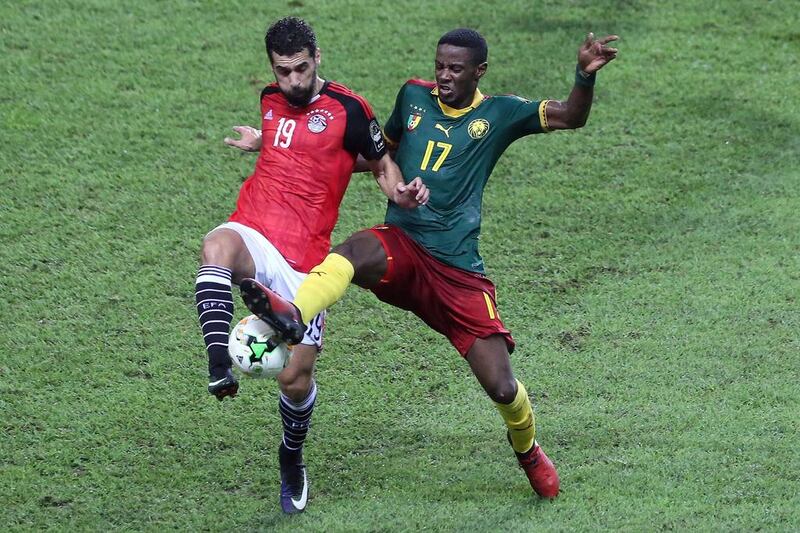 Egypt forward Abdallah Said, left, vies for the ball against Cameroon midfielder Arnaud Sutchuin-Djoum. Steve Jordan / AFP