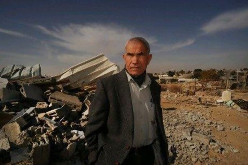 Nuri Al Okbi next to his nephew's demolished house in Hirbat Khurah village.