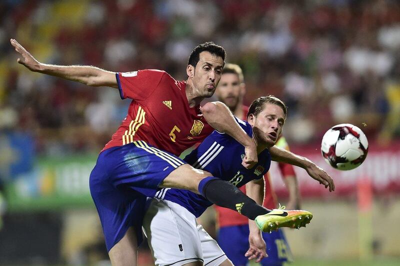 Spain midfielder Sergio Busquets, left, duels for the ball with Liechtenstein’s Sandro Wieser. Alvaro Barrientos / AP Photo