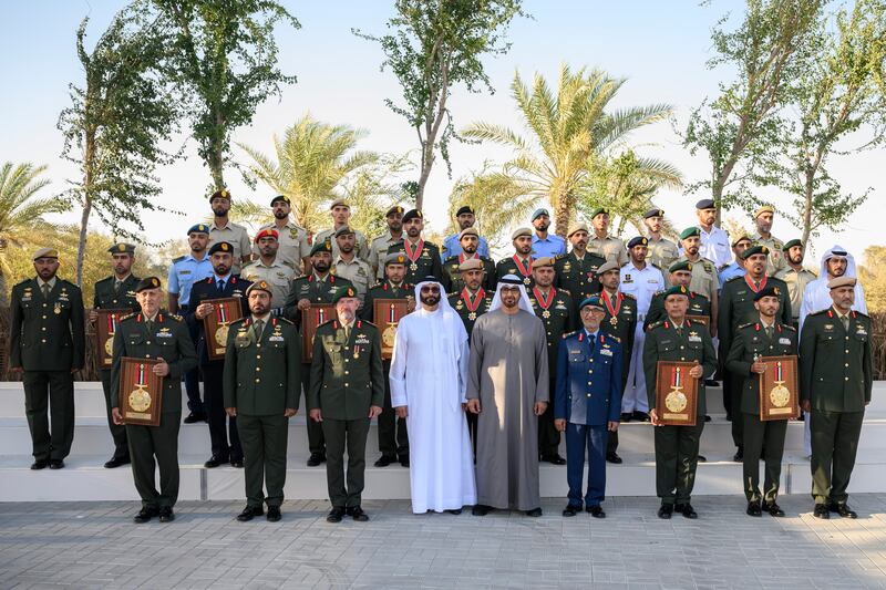 President Sheikh Mohamed with Mohamed Ahmad Al Bowardi, fourth from left, Maj Gen Essa Saif Al Mazrouei, sixth from left, and members of the Armed Forces