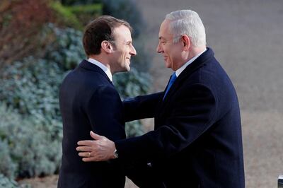 French President Emmanuel Macron, left, greets Israeli Prime Minister Benjamin Netanyahu before a meeting at the Elysee Palace in Paris, Sunday, Dec.10, 2017. Hundreds of pro-Palestinian protesters have demonstrated in Paris against the arrival of Israeli Prime Minister Benjamin Netanyahu saying his visit to meet French President Emmanuel Macron is not welcome, especially following this week's declaration by US President Donald Trump that Jerusalem is Israel's capital city. (AP Photo/Christophe Ena)
