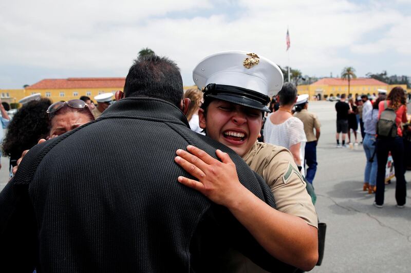 Private First Class Ann Parra hugs her father, as members of Lima Company's 3rd Recruit Training Battalion celebrate after becoming the first women to graduate as US Marines in the 100-year history of Marine Corps Recruiting Depot San Diego, California. Reuters