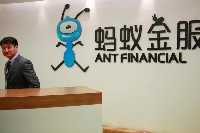 FILE PHOTO: An employee stands next to the logo of Ant Financial Services Group, Alibaba's financial affiliate, at its headquarters in Hangzhou, Zhejiang province, China January 24, 2018. REUTERS/Shu Zhang/File Photo