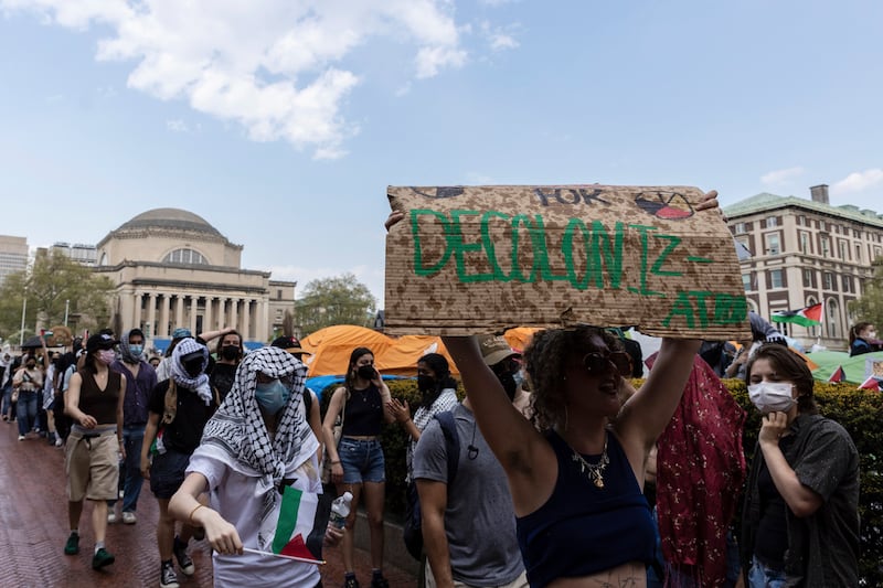 Student protesters march round their encampment at Columbia University. AP