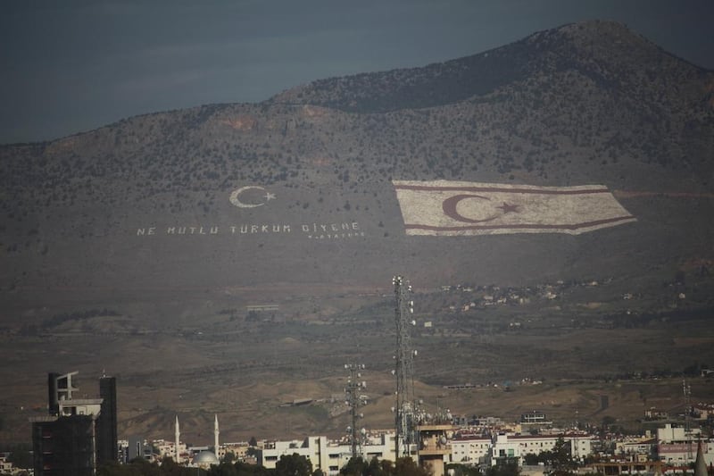 A giant Turkish flag embossed on a mountain overlooking Nicosia in southern Cyprus. Turkey has warned Cyprus and oil firms against making any energy grabs as talks founder again. Josh Wood : The National