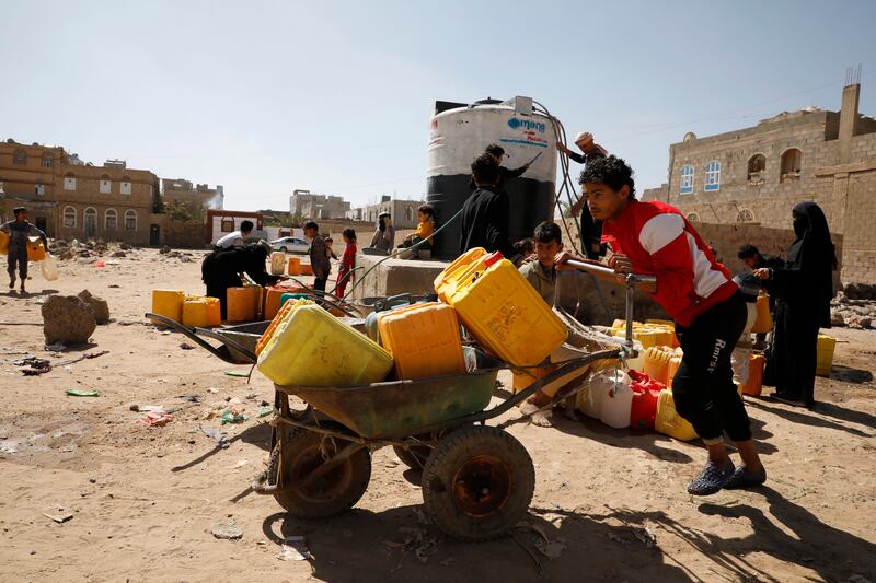 A man collects water on the outskirts of Sanaa. Attacks on Yemen's ports are affecting the distribution of much-needed resources. EPA