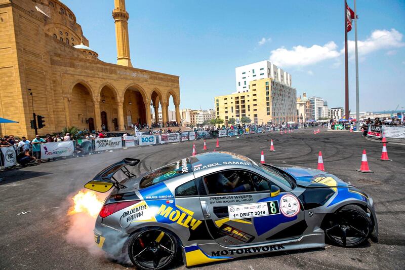 An auto enthusiast performs drift stunts during a special motoring event in the Lebanese capital Beirut outside the Mohammad al-Amin mosque in the downtown district's Martyr's Square.  AFP