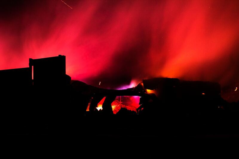 Smoke rises from the burnt structure of a factory during the Tick Fire near Santa Clarita. EPA