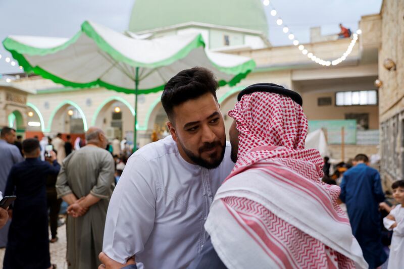 Sunni worshippers exchange greetings after Eid al-Fitr prayers to mark the end of the fasting month of Ramadan in Mosul, Iraq. Reuters