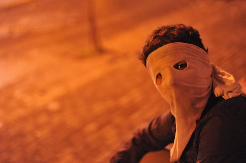 A protester wearing a mask poses for a photograph in a street in the Gezi district of Istanbul. Turkey’s combative prime minister warned protesters that police would do “whatever is necessary” to clamp down on demonstrations in Istanbul’s Taksim Square to mark the anniversary of last year’s turmoil. Ozan Kose / AFP 