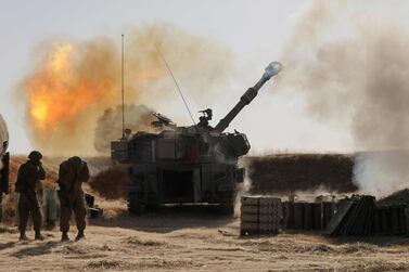 Israeli soldiers fire a 155mm self-propelled howitzer towards targets in the Gaza Strip from their position near the southern Israeli city of Sderot on May 12, 2021. AFP