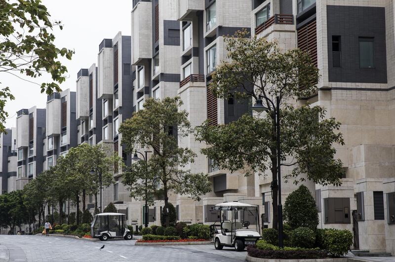 Golf carts stand parked in front of low-rise buildings in Discovery Bay, a residential project developed by Hong Kong Resort Co., on Lantau Island in Hong Kong, China, on Tuesday, March 27, 2018. As carmakers race to sell glitzy new models to wealthy Chinese, the old-fashioned golf cart is the hottest buy in one corner of Hong Kong, with prices topping those of a Tesla Model S and Porsche's Boxster sports cars. Photographer: Justin Chin/Bloomberg