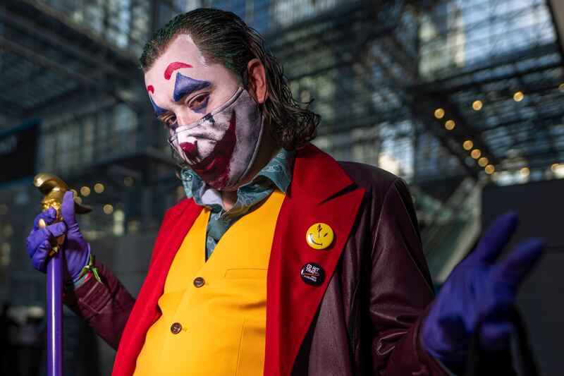 A Joker cosplayer poses during New York Comic Con. Charles Sykes / Invision / AP