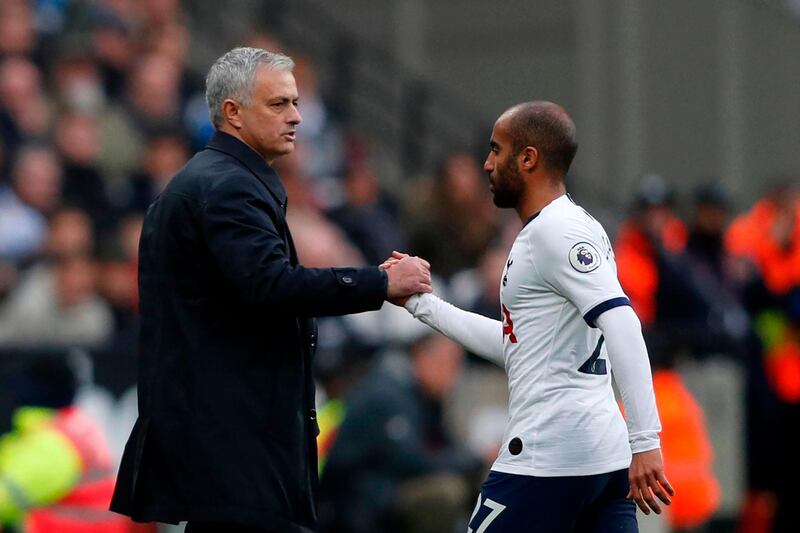 Tottenham Hotspur's Portuguese head coach Jose Mourinho (L) shakes hands with Lucas Moura as he leaves the field. AFP