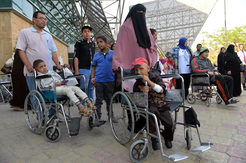 Cancer patients, including children, gather outside Hospital 57357 in Cairo. The number 57357 is the bank account number that accepted donations from the public to build the hospital. AFP
