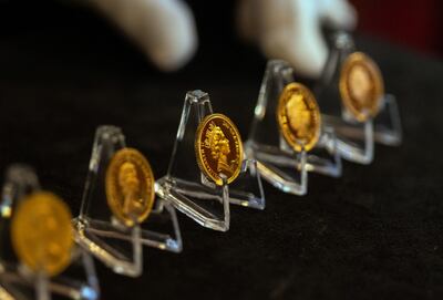 A display of coins showing the five versions of Queen Elizabeth II's head used over her lifetime. Bloomberg