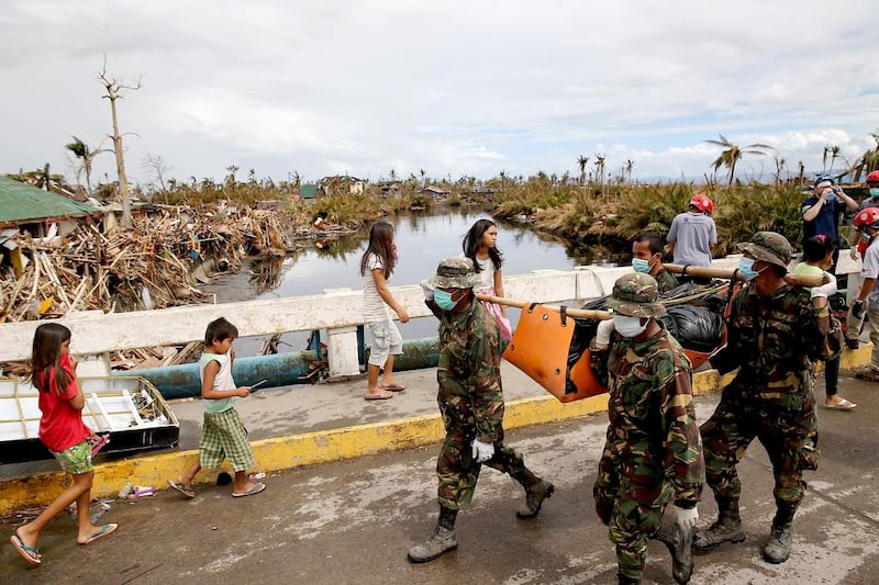 Philippines soldiers carry a body collected from the rubble in the devastated town of Tanauan on Saturday in Leyte, Philippines. Dan Kitwood / Getty Images