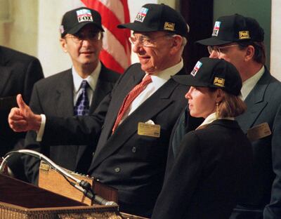 Rupert Murdoch, (2L) chairman of Fox Entertainment Group, Inc., gestures from a podium at the New York Stock Exchange before ringing the opening bell November 13. Murdoch visited the NYSE to mark the initial public offering on November 11 of stock in Fox Entertainment Group. The offering, which raised $2.8 billion, is the third largest ever, behind Conoco's $4.5 billion offering and the $3 billion spin-off of Lucent technologies. Stock exchange chairman Richard Grasso is at left, Jessica Reif Cohen of Merrill Lynch is in right foreground, and Fox senior vice-president David DeVoe is far right.

PM/KM