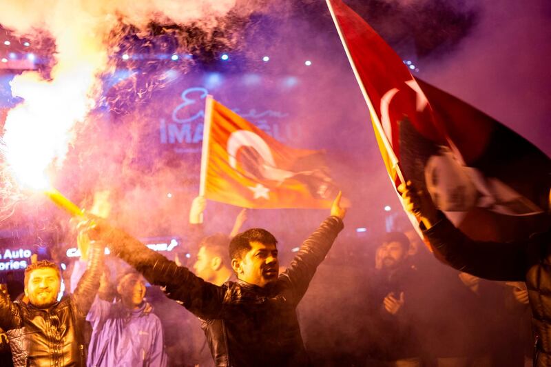 Supporters of the CHP wave flags and light up torches in Istanbul. AFP
