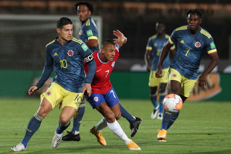 James Rodriguez and Alexis Sanchez battle for the ball. AP