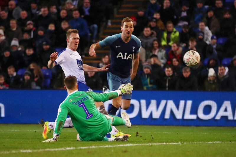 BIRKENHEAD, ENGLAND - JANUARY 04:  Harry Kane of Tottenham Hotspur scores his team's seventh goal past Scott Davies of Tranmere Rovers during the FA Cup Third Round match between Tranmere Rovers and Tottenham Hotspur at Prenton Park on January 4, 2019 in Birkenhead, United Kingdom.  (Photo by Clive Brunskill/Getty Images)