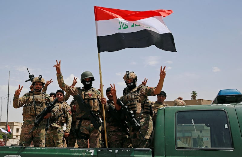 Members of Iraqi forces take part in a victory celebration after defeating Islamic State militants and retaking the Grand Al-Nuri Mosque in Mosul, on July 2, 2017.  Erik De Castro / Reuters