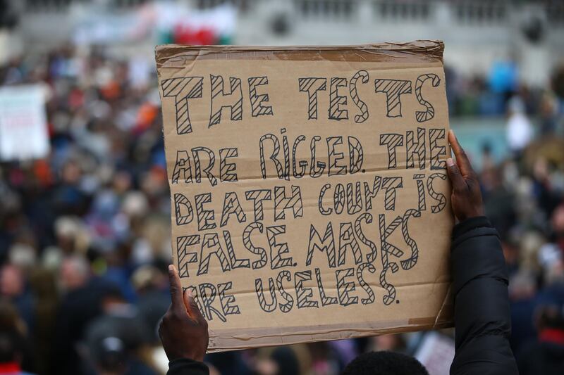A protestor holding a placard attends a Resist and Act for Freedom anti-mask rally at Trafalgar Square. Getty Images