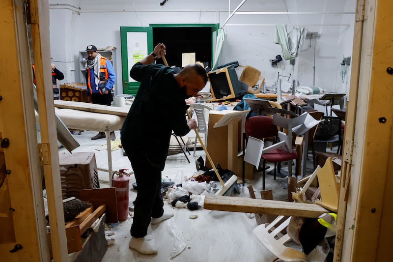 Palestinians clean up Al Aqsa Mosque compound after Israeli police stormed the site. Reuters