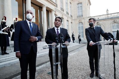 French President Emmanuel Macron, wearing a protective face mask, talks to the press with Mohamed al-Menfi, Head of the Presidential Council of Libya and Musa al-Koni, Vice-President of the Presidential Council of Libya after a meeting at the Elysee Palace in Paris, France, March 23, 2021. REUTERS/Benoit Tessier