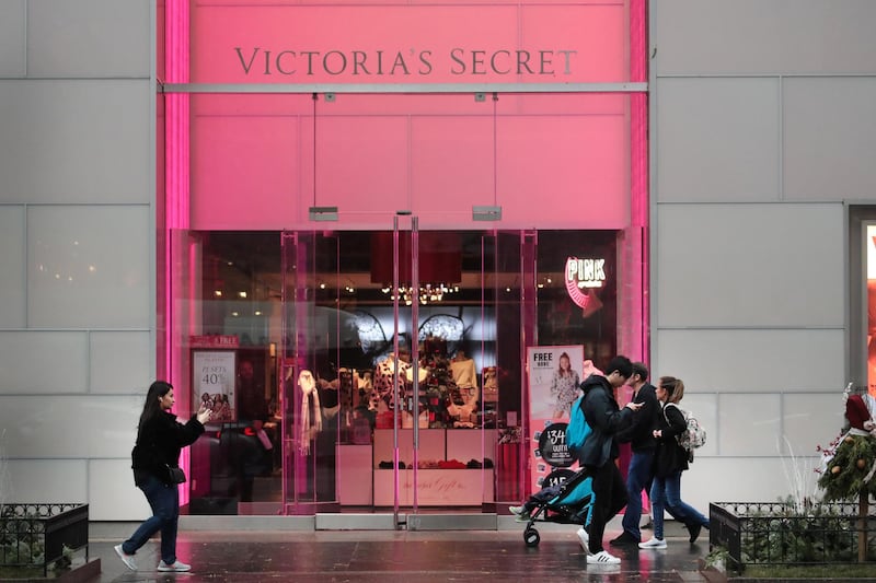 CHICAGO, ILLINOIS - NOVEMBER 21: Shoppers walk past a Victoria's Secret store along the Magnificent Mile on November 21, 2019 in Chicago, Illinois. According to the parent company L Brands, sales dropped 7 percent at Victoria's Secret stores open for at least a year during the latest quarter compared with the same period last year.   Scott Olson/Getty Images/AFP