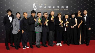Team members of movie "My Missing Valentine" hold their awards for press at the 57th Golden Horse Awards in Taipei, Taiwan, Saturday, Nov. 21, 2020. Golden Horse Awards is considered Asia's equivalent of the Academy Awards for Chinese-language films. (AP Photo/Billy Dai)