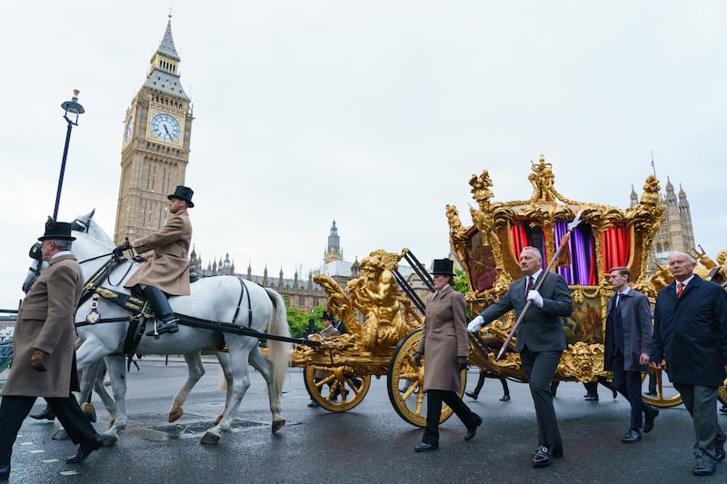 The gold state coach passes the Houses of Parliament during an early morning rehearsal through London for Sunday's platinum jubilee pageant. PA