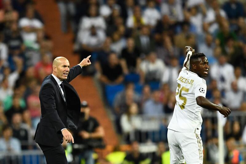 Real Madrid's French coach Zinedine Zidane (L) and Real Madrid's Brazilian forward Vinicius Junior gesture during the UEFA Champions league Group A football match between Real Madrid and Club Brugge at the Santiago Bernabeu stadium in Madrid.   AFP