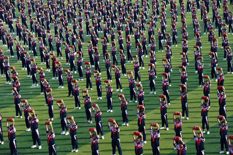 Students perform with waist drums during the opening ceremony of a sports meeting in Xiangyang, Hubei province. China Daily via Reuters