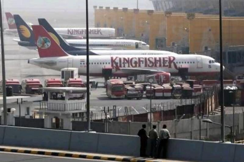 Kingfisher airlines aircrafts stand parked at the Indira Gandhi International Airport in New Delhi, India, Tuesday, Feb. 21, 2012. India's top aviation watchdog ordered troubled Kingfisher Airline to explain dozens of canceled flights as the carrier battled mounting financial troubles. (AP Photo/ Mustafa Quraishi) *** Local Caption *** India Kingfisher Airlines.JPEG-0e5da.jpg