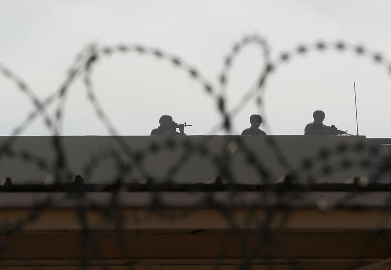 US embassy security personnel take their position on the roof. Reuters