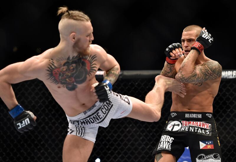 LAS VEGAS, NV - SEPTEMBER 27:  (L-R) Conor McGregor of Ireland kicks Dustin Poirier in their featherweight bout during the UFC 178 event on September 27, 2014 in Las Vegas, Nevada. (Photo by Jeff Bottari/Zuffa LLC/Zuffa LLC via Getty Images)