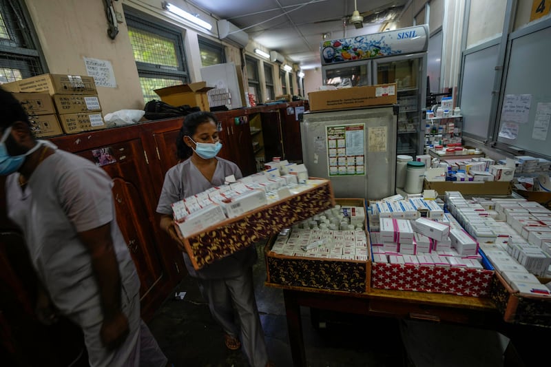A hospital worker carries a tray of drugs at a government-run hospital in Colombo. AP Photo