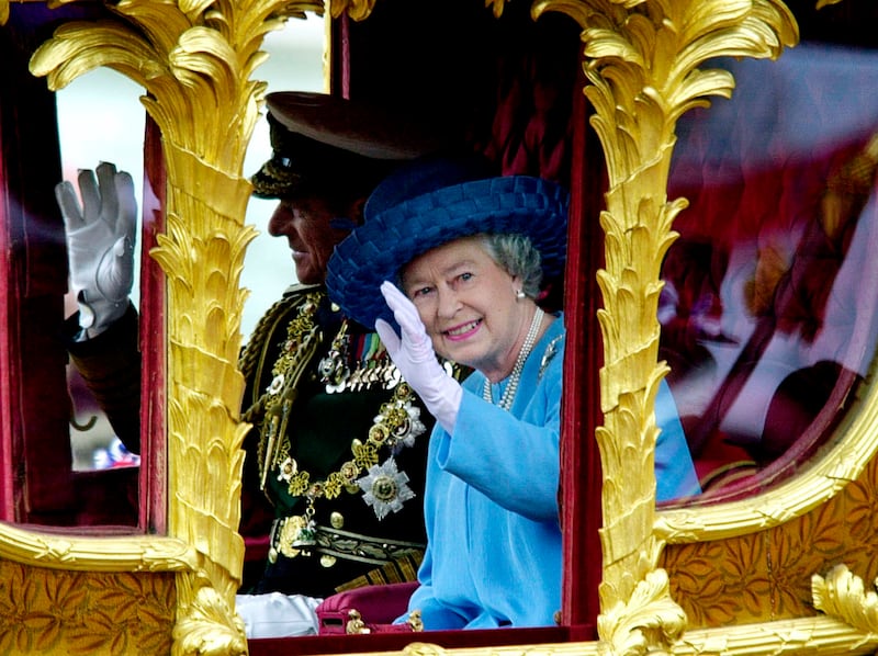 June 4, 2002: The Queen and her husband the Duke of Edinburgh wave to well-wishers, as they ride the Gold State Coach from Buckingham Palace to St Paul's Cathedral in London, for a service of thanksgiving to celebrate her Golden Jubilee. AP 