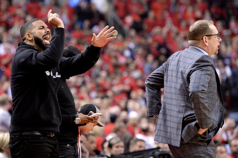Drake reacts as Toronto Raptors coach Nick Nurse walks past during the first half of Saturday's action. Game 6.