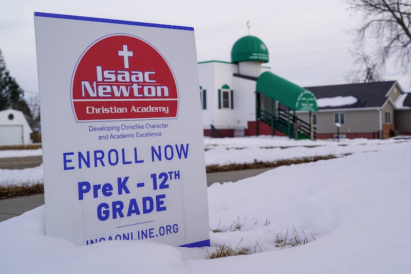 A sign for a Christian academy rests in front of the Mother Mosque of America. 