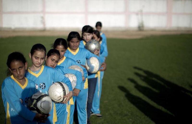 Palestinian girls tarining at the Beit Lahia football club in the northern Gaza strip as part of an after-school sport program funded by the Palestine Association for Children’s Encouragement of Sports. Mahmud Hams / AFP 

