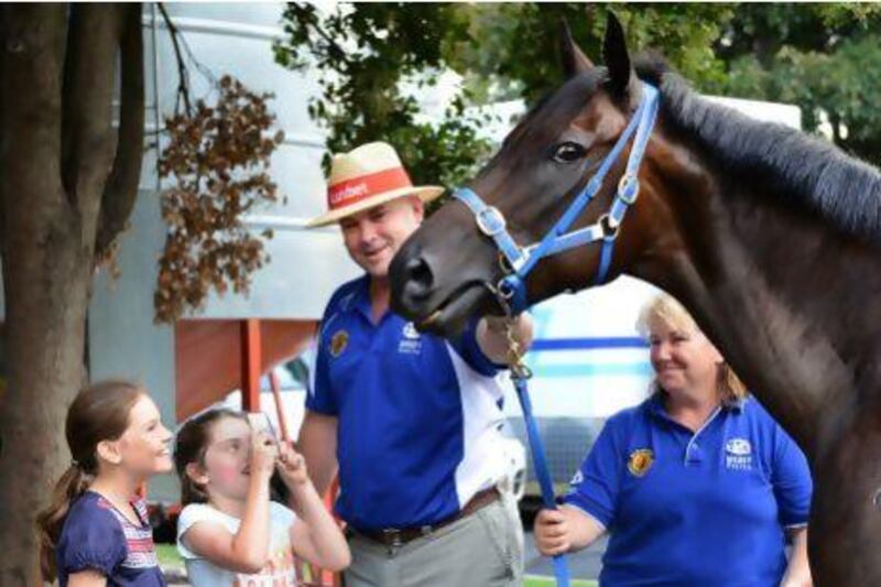 Trainer Peter Moody gives Matilda Garvey and Mia Allen, left, a close look at Black Caviar at a media call at Caulfield Racecourse on February 14 in Melbourne, Australia.