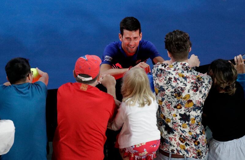 Serbia's Novak Djokovic signs autographs after defeating Russia's Daniil Medvedev in their fourth round match at the Australian Open tennis championships in Melbourne, Australia, Tuesday, Jan. 22, 2019.(AP Photo/Aaron Favila)