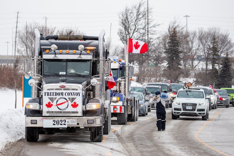 People gather to support drivers protesting over Covid-19 vaccine mandates for cross-border truckers. Reuters