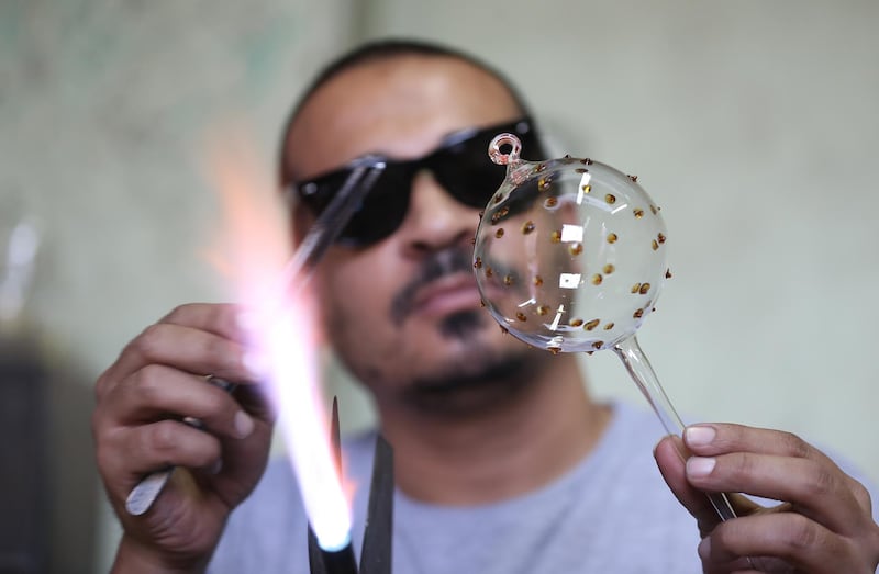Egyptian worker Mosaad Masoud makes glass items for decorating Christmas trees at a glass workshop in Al Qalyubia Governorate, north of Cairo, Egypt. Most Egyptian Christians belong to the Coptic Orthodox Church and they have some very unique traditions for Christmas, which they celebrate on 07 January according to the Julian calendar.  EPA