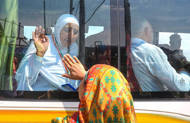 A Kashmiri pilgrim waves goodbye. EPA